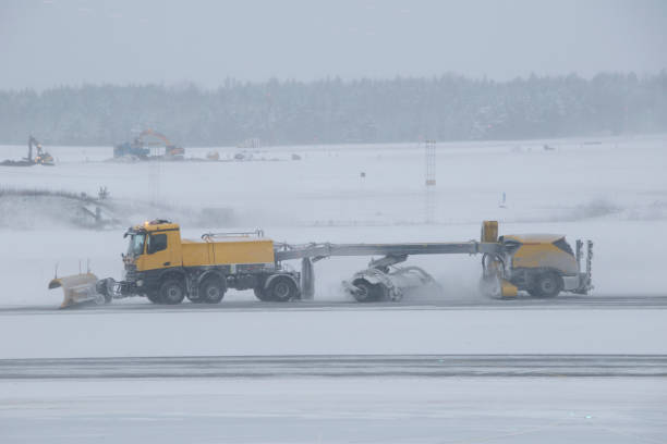 istock Airplane runway snow plower cleaning the runway. 1299805392