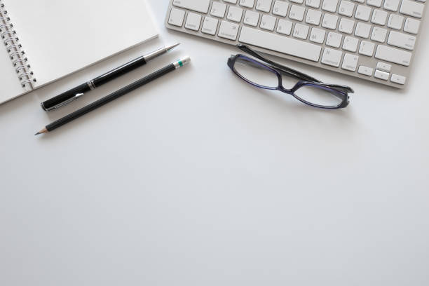 istock top view of workspace with computer keyboard and office supplies on white desk with copy space 1299806732