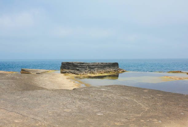 Kocaeli, Turkey-June 23, 2012: Shallow Marmara Sea Waters and Green Algae at Kefken Pink Rocks. It is a touristic place due to its interesting geological structure. Soft rocks in the water harden after removal. Kefken is a neighborhood in Kocaeli province's Kandira district.
