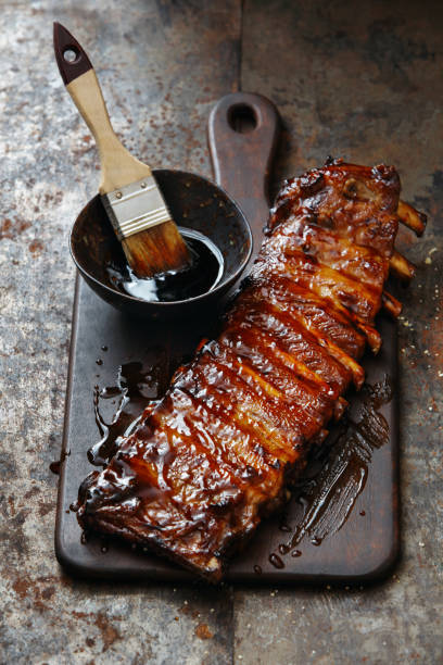 Spicy Glazed Pork Ribs Grilled Spicy Glazed Pork Ribs. Close-up composition on dark background. barbeque sauce photos stock pictures, royalty-free photos & images
