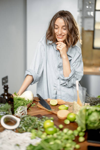 istock Woman with green ingredients on the kitchen 1299807251