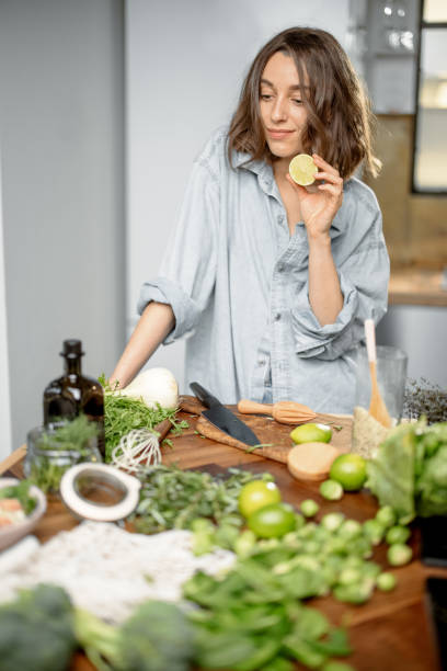istock Woman with green ingredients on the kitchen 1299807778