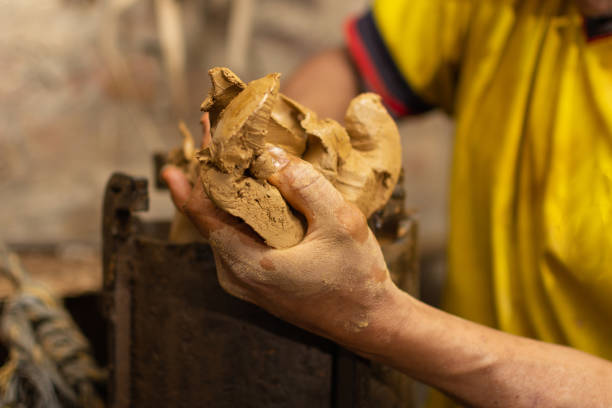 istock Artisan hand with raw clay. Shallow depth of field 1299809200
