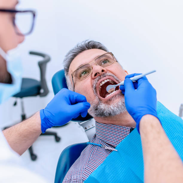 istock Mature man at the dentist 1299809809