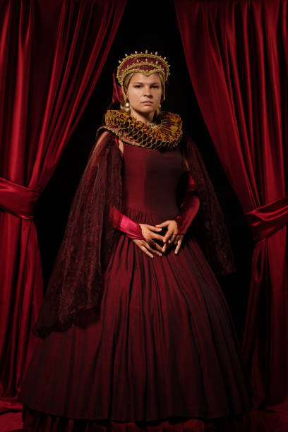Historical Queen character in a studio shoot Beautiful historical blond Queen character wearing a period dress in a studio shot cosplay character stock pictures, royalty-free photos & images