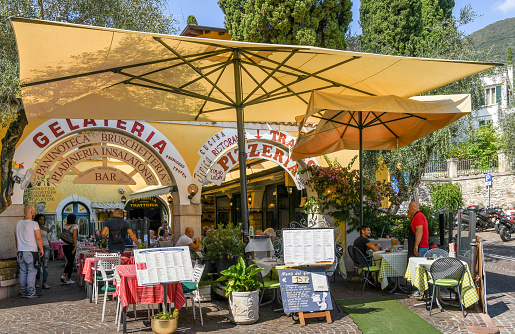 Gardone Riviera, Lake Garda, Italy - September 2018: Front of a bar, ice cream parlour and pizzeria in Gardone Riviera near the entrance to the Vittoriale degli Italiani gardens
