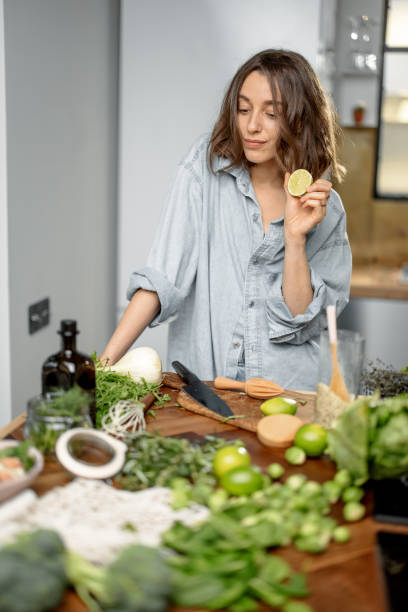 istock Woman with green ingredients on the kitchen 1299813909