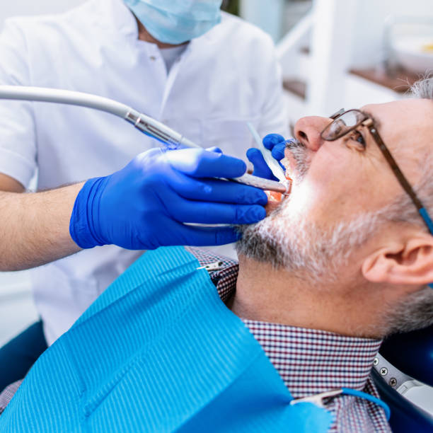 istock Mature man at the dentist 1299814181
