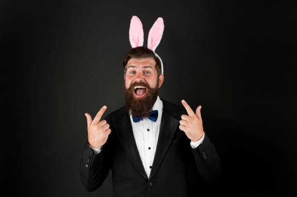 istock Handsome man wear bunny costume accessory. Easter day. Event host. Celebrate Easter. Let me be your bunny. Celebration Easter holiday. Bearded man with long ears. Businessman with long ears 1299814215
