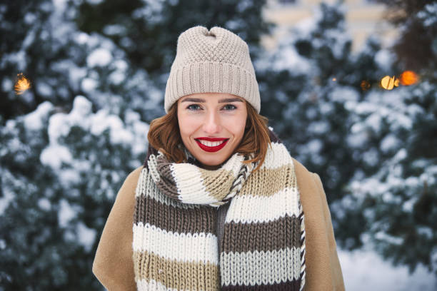 istock Smiling pretty woman standing in winter forest 1299814511