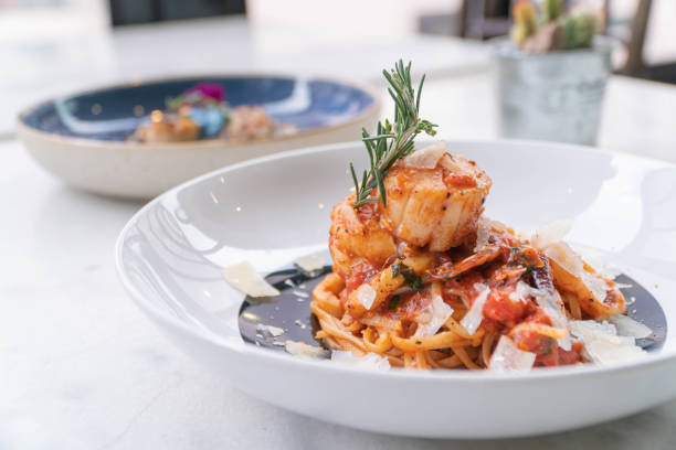 istock Spaghetti with prawns, sea scallops and parmesan 1299816871