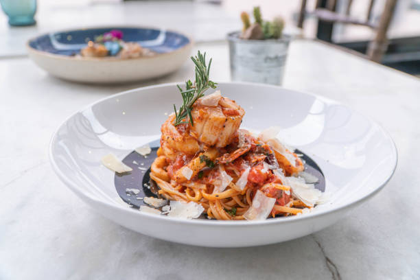 istock Spaghetti with prawns, sea scallops and parmesan 1299816916