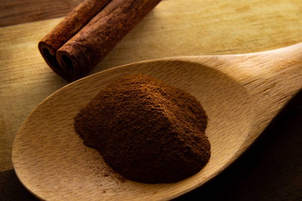 istock Powdered cinnamon in wooden spoon. 1299818705