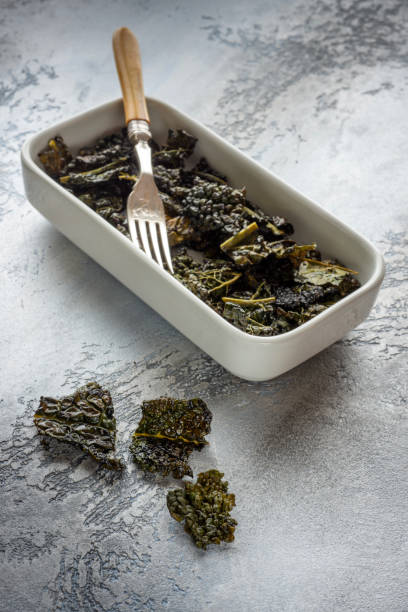 istock Baked kale chips with poppy seeds 1299818927