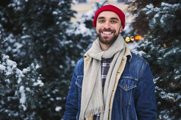 istock Jolly young man walking in winter forest 1299820561