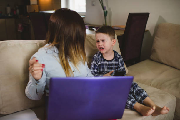 istock Woman working from home during quarantine with her little son 1299824537