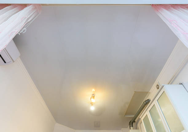 istock A budget ceiling made of white plastic panels in a spacious kitchen 1299826575