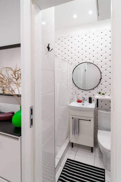 istock Classical bathroom interior with white furniture 1299827957