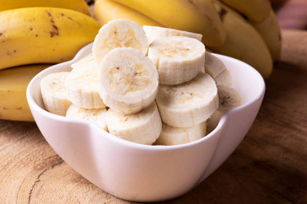 istock Chopped bananas in a white bowl 1299828460