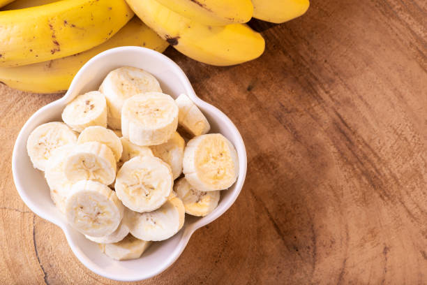 istock Chopped bananas in a white bowl 1299828461