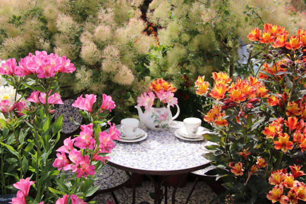 Beautiful interior with white furniture (table and park bench) and a garden lattices decorated with flowers