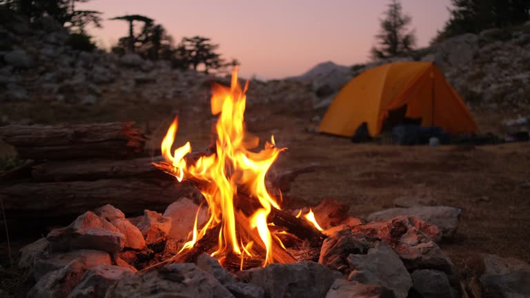 Bonfire burning in tourist camp in mountains.