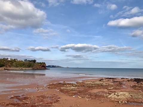 Broadsands Sandy beach in South Devon. Picture shows the red sand as tide is out. Ripples in the sea and pretty clouds