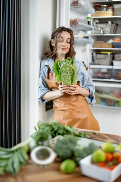istock Woman with roman salad on the kitchen 1299832957