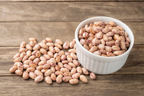 istock Brown beans on a bowl over wooden table 1299833328