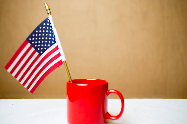istock Small American flag in a red coffee cup. 1299836314