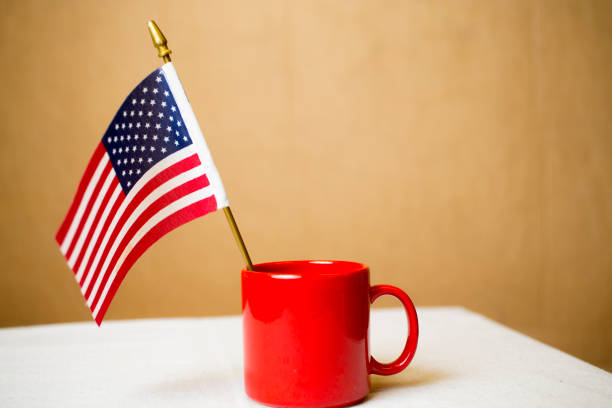 Small American flag in a red coffee cup.