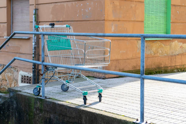 istock Abandoned empty grocery cart in an old street courtyard 1299837467