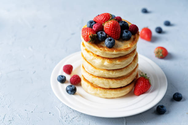 istock pancakes with chocolate glaze, strawberries, blueberries and raspberries 1299838382