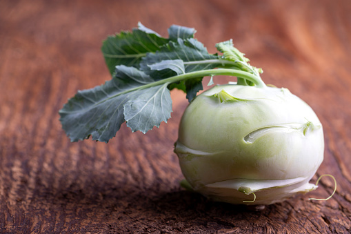 single raw cabbage turnip on wood