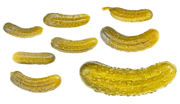 istock Set of marinated pickled cucumbers isolated on a white background, top view. Pickled gherkins. 1299838548