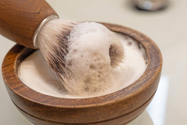 istock wooden bowl with soap and razor brush 1299839556