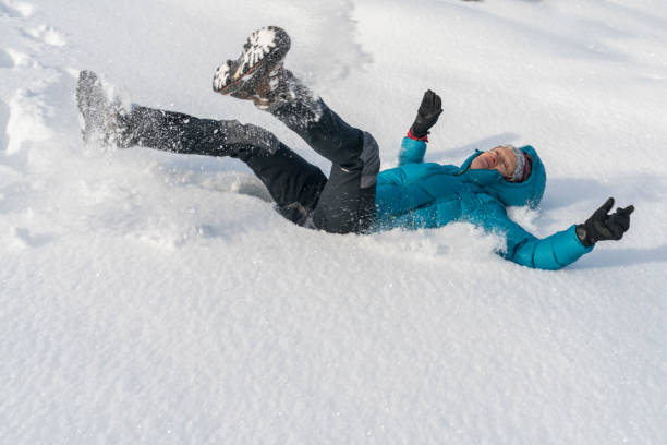 istock Mature women throwing herself in fresh snow 1299840558
