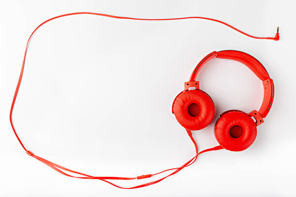 istock Red round headphones with a cord forming a frame flat lay on a white background with a copy space 1299840840