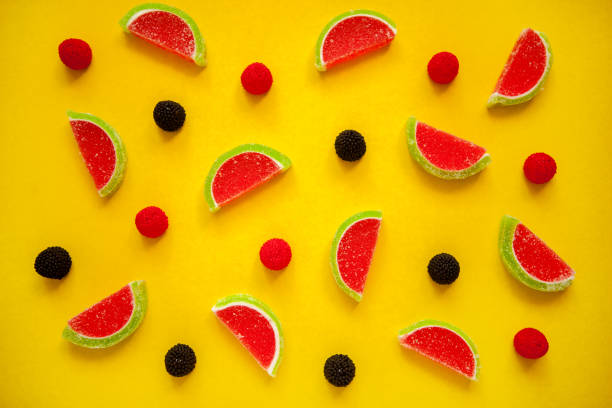 istock Fruit jelly segments in the form of watermelon on yellow 1299841020