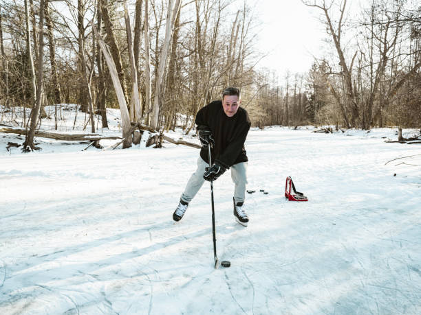 istock Mature man playing hockey outdoors 1299843580