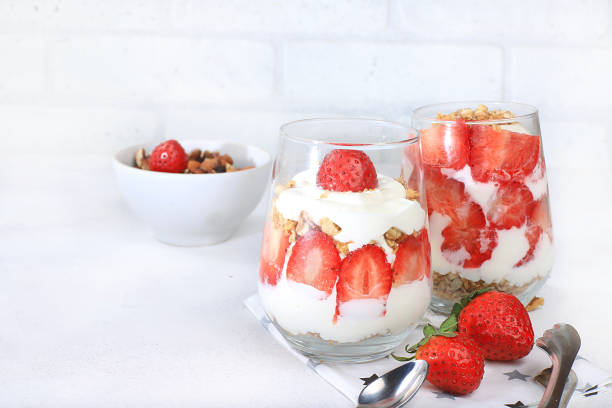 istock Strawberry yogurt with berries and muesli on a bright table, fruit salad. Useful breakfast with ingredients. Healthy and natural food concept, lifestyle, food for children, selective focus, 1299843794