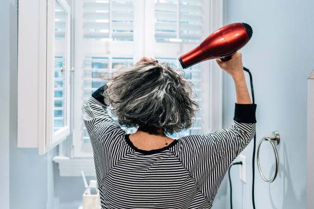 Woman drying hair Woman drying hair in Bathroom blow drying stock pictures, royalty-free photos & images