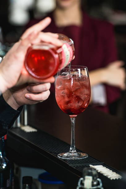 istock bartender making refreshing pink coctail with a rose on top isol 1299845060