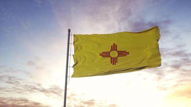 風に手を振るニューメキシコ州の国旗。ドラマチックな空の背景。3d イラスト - new mexico flag ストックフォトと画像