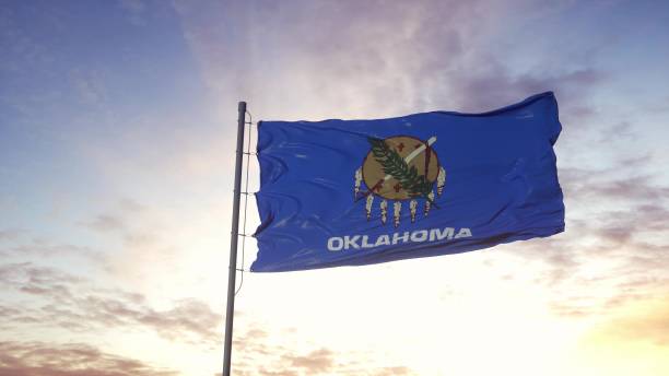 istock State flag of Oklahoma waving in the wind. Dramatic sky background. 3d illustration 1299845677