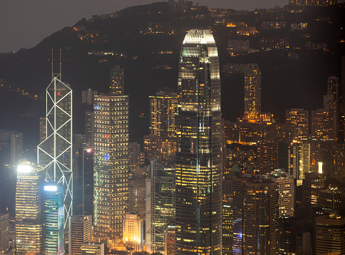 Skyscrapers illuminated at night in Hong Kong, China.