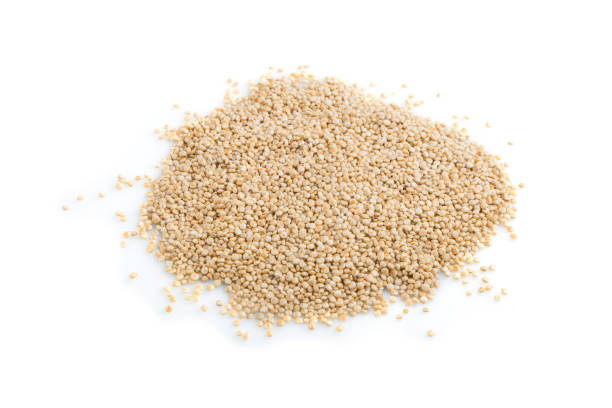 istock Pile of raw white quinoa isolated on white background. Side view, close up, macro. 1299846898