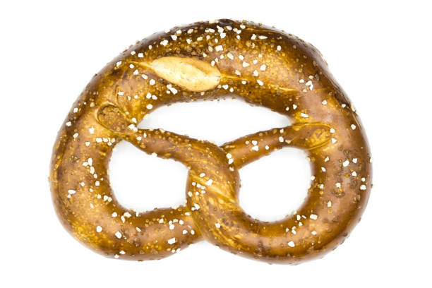 istock Bavarian pretzel with salt isolated on white background top view 1299847038