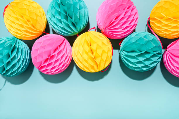 istock Colored Garlands for the carnival on a blue background. Bright festive decor. Poster or postcard. Copy space. High quality photo in hard light. High quality photo 1299848021