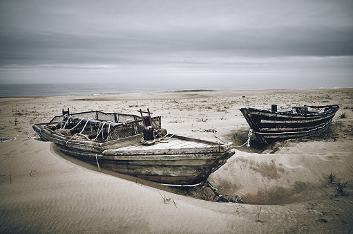 Fishing old wooden boats on the beach sand near the sea, Sakhalin island, Russia